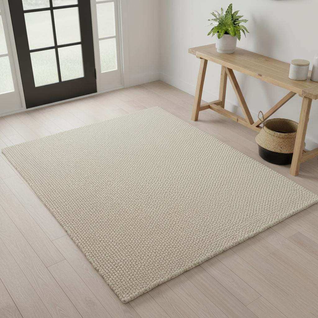 Handwoven Neutral Wool area rug in a soft beige tone with a tactile loop texture, natural wool fibre, and minimalist design.
