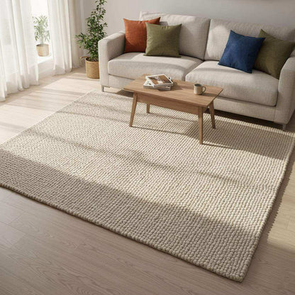 Handwoven Neutral Wool area rug in beige with a loop-textured surface, natural fibre, cozy tactile wool carpet.