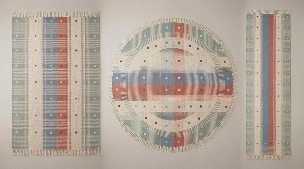 Handwoven tartan flatweave rug in sage green and terracotta with Scandinavian modern plaid design