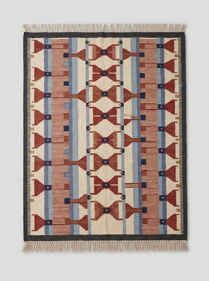 Handwoven wool flatweave rug with geometric kilim design in terracotta, blue, and ivory colors for living room decor