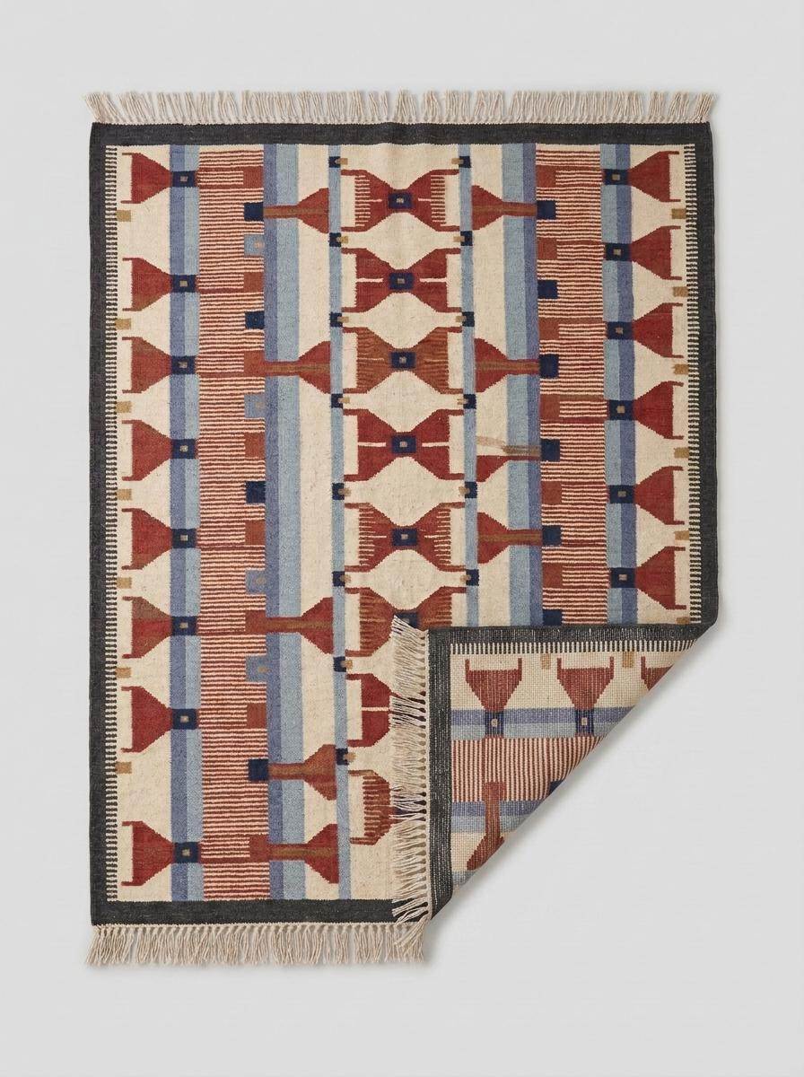 Handwoven wool flatweave rug with geometric kilim pattern in terracotta, blue, and cream colors, flatwoven and reversible.
