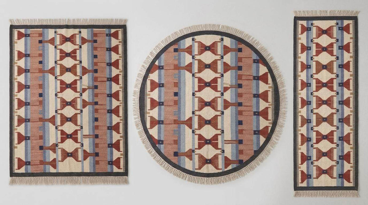 Handwoven wool flatweave rug with geometric kilim pattern in ivory, terracotta, blue, and gray colors for living room decor