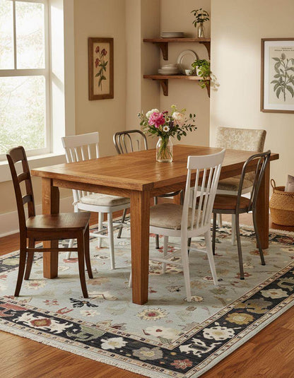 Light blue Oushak rug with navy border and floral medallion design in wool hand-tufted carpet