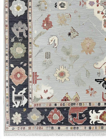 Light Blue Oushak Rug with navy border and floral medallion design, hand-tufted wool carpet