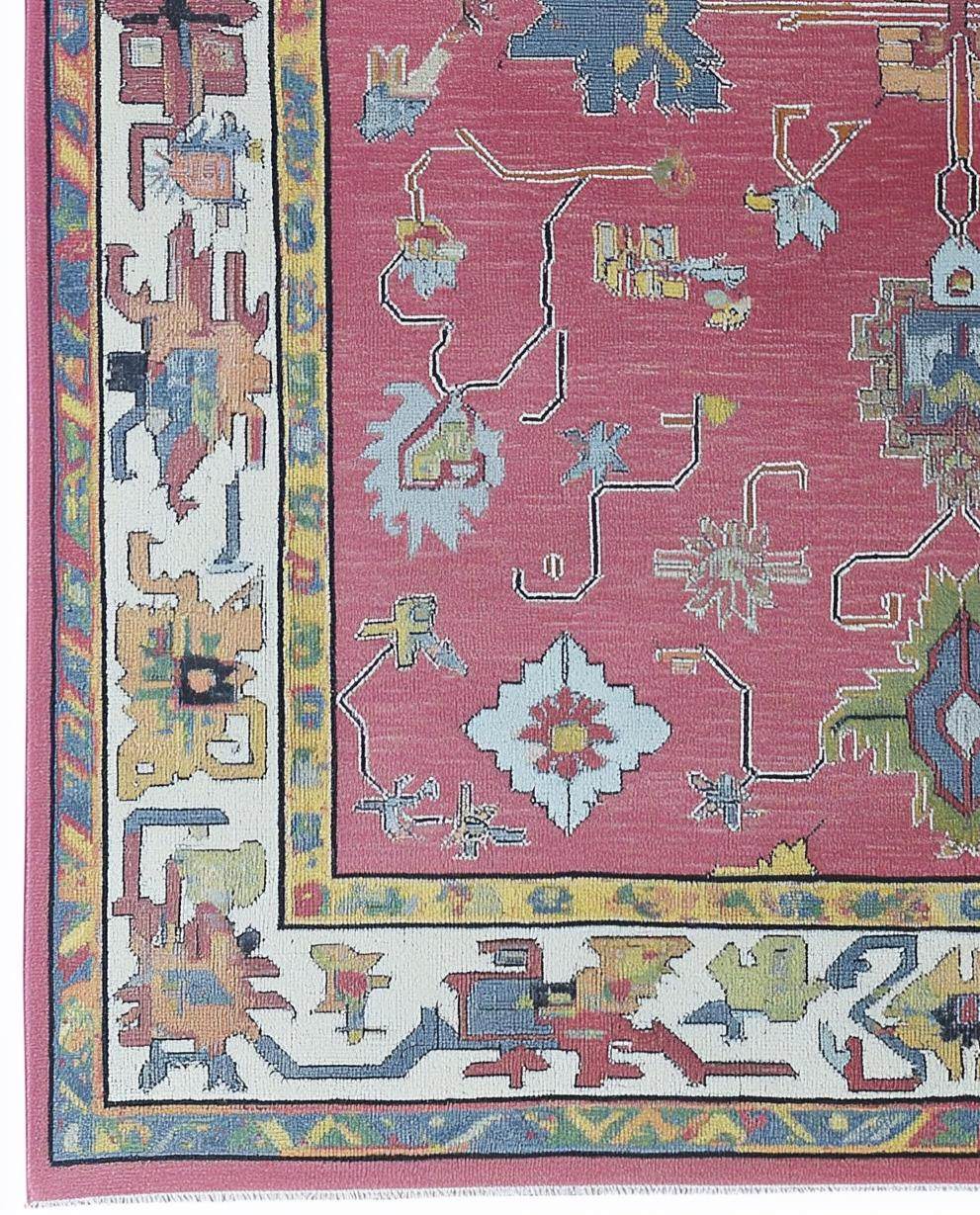 Red abstract floral knotted area rug with multicolor geometric motifs and detailed border in boho Turkish style