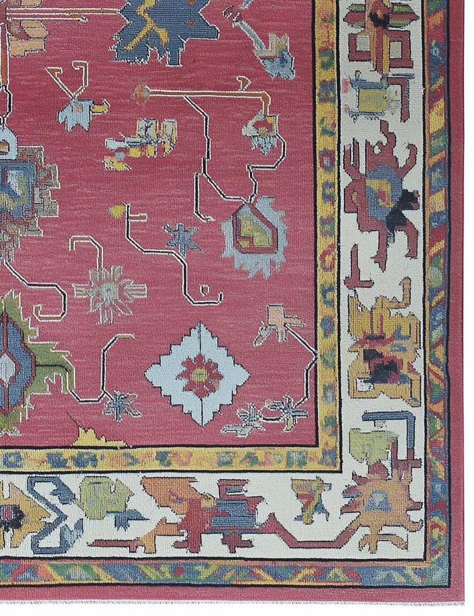 Red abstract floral knotted area rug with colorful motifs and detailed border in boho Turkish style