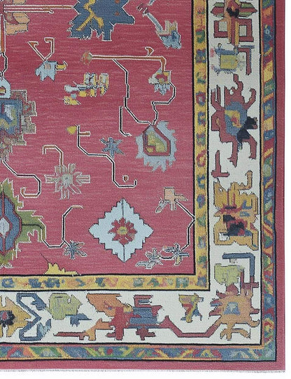 Red abstract floral knotted area rug with colorful motifs and detailed border in boho Turkish style
