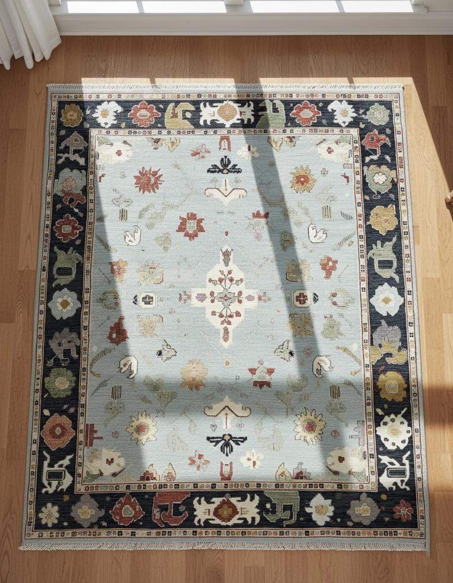 Light Blue Oushak Rug with navy border and floral medallion pattern, hand-tufted wool carpet for elegant transitional interiors