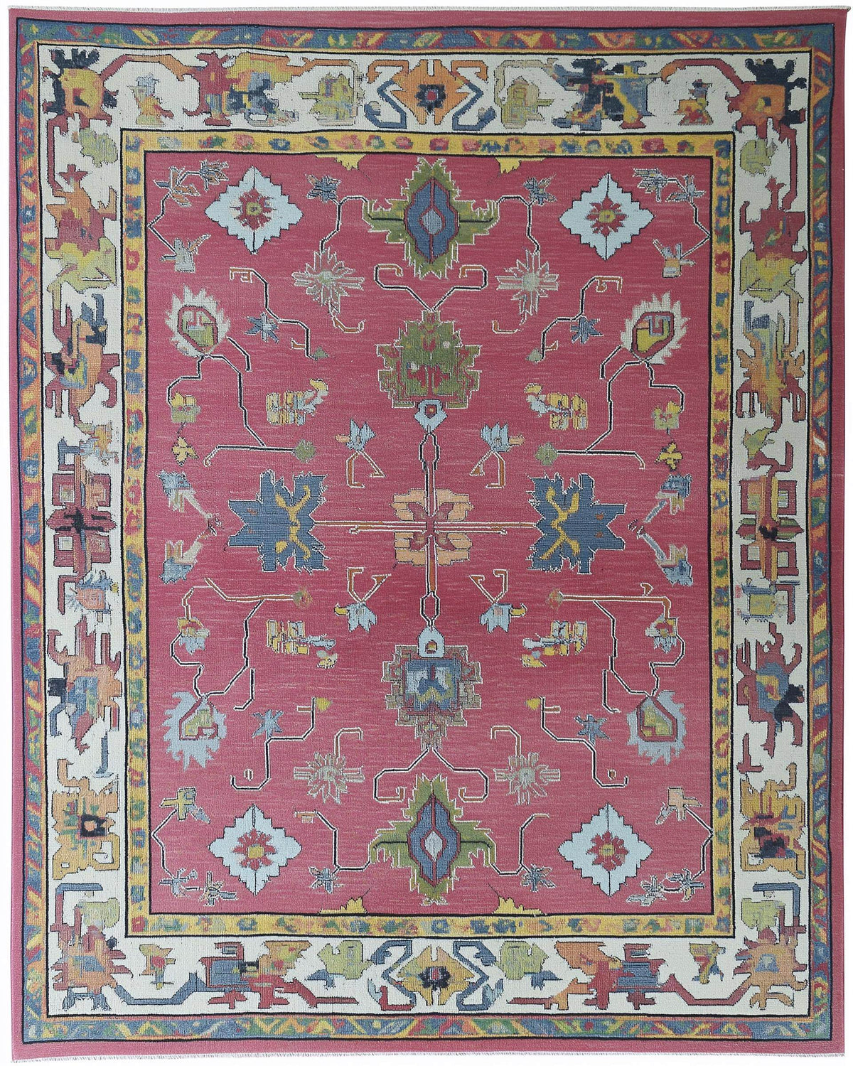 Full view of a rose pink Oushak style area rug with multi-color geometric and floral medallions; hand-tufted.