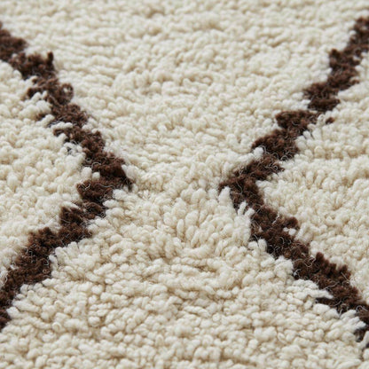 Handmade Moroccan shag rug in ivory with dark brown diamond pattern, plush high-pile boho accent for living room or bedroom