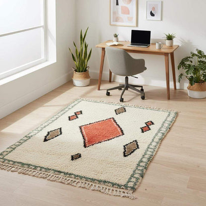 Handmade wool area rug with geometric diamond pattern in cream, brick red, tan, and muted green boho Moroccan style