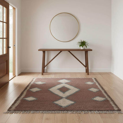 Vintage hand-woven Moroccan rug with brown base, cream diamond pattern, and blue edging in bohemian style