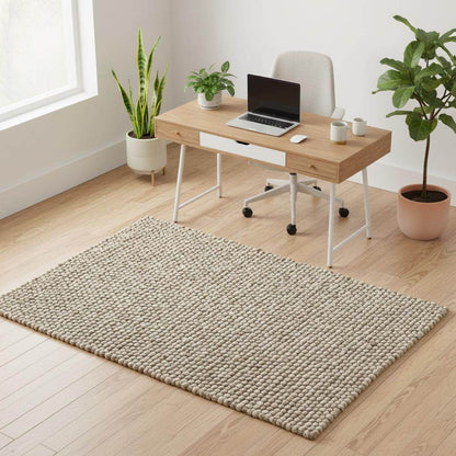 Handmade textured wool mat in natural beige pebble design for modern home decor