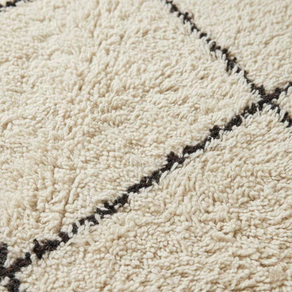 Oversized Beni Ourain wool rug with ivory base and black diamond pattern hand-knotted Moroccan design