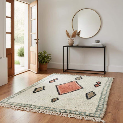 Handmade wool area rug with geometric diamond pattern in cream, brick red, tan, and muted green boho Moroccan style