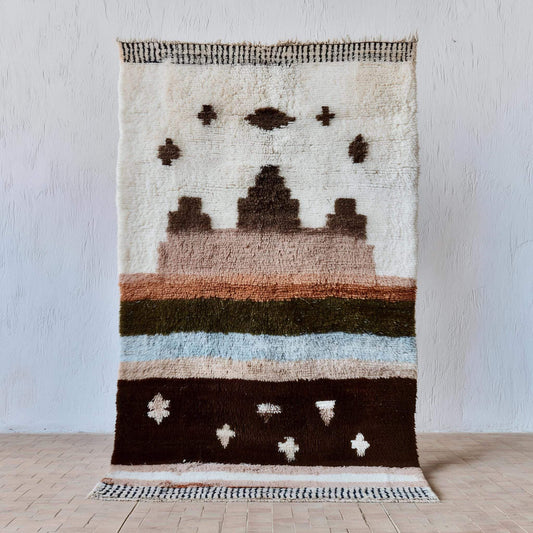 Handmade Moroccan wool rug with earthy Berber design in warm clay, cream, dark brown, olive, and muted blue tones for boho home decor