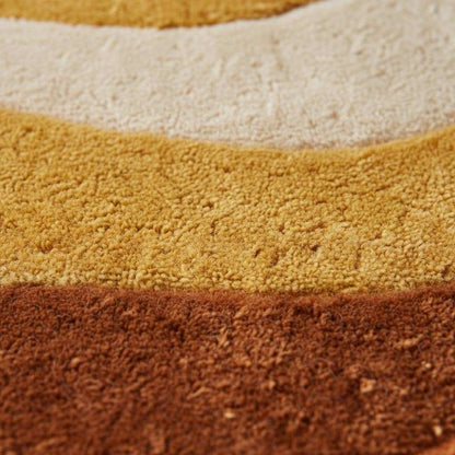 Retro sculpted shag rug with 70s wave pattern in mustard orange vintage mid century modern carpet