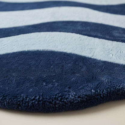 Modern wavy rug with abstract navy and light blue curved design for contemporary living room decor