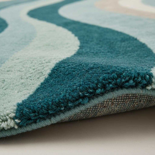 Close-up detail of a handmade tufted rug showing textured wool and stitching