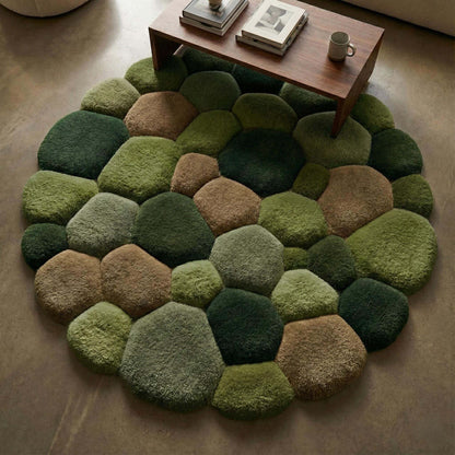 Soft nature-inspired stone rug in multiple green shades, showing plush tufted texture resembling moss and river rocks.