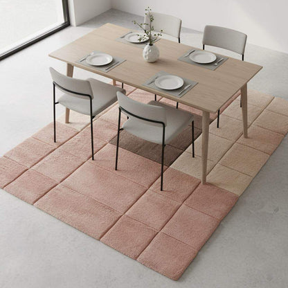 Warm neutral and blush modern rug with subtle geometric shapes enhancing a minimalist interior setting.