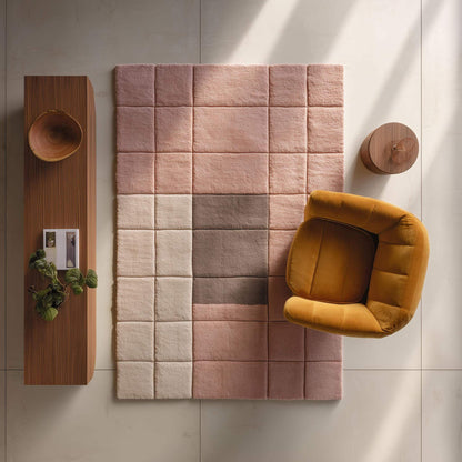 Modern geometric rug with plush pink neutral tones and textured grid pattern
