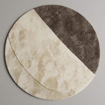 Soft plush round rug featuring a half-moon cream and taupe pattern styled with modern furniture, neutral home décor aesthetic.