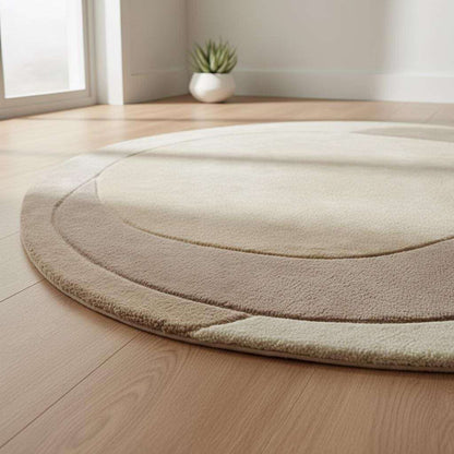 Contemporary organic-shape area rug with layered beige tones under minimalist armchairs.