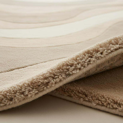 Beige cream area rug with wavy pattern in minimalist living room setting