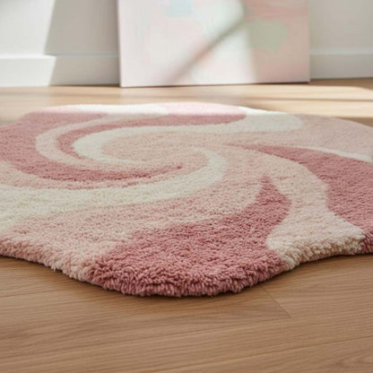 Pink abstract rug with irregular shape and wavy swirl pattern on plush shag material