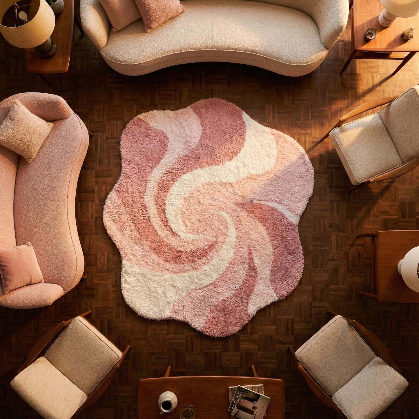 Pink abstract rug with irregular shape and wavy swirl pattern in plush shag material