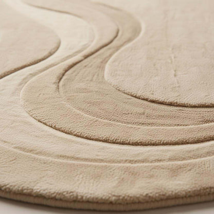 Close-up detail of a handmade tufted rug showing textured wool and stitching