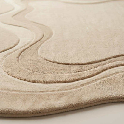 Organic irregular shaped hand tufted wool rug in minimalist living room setting