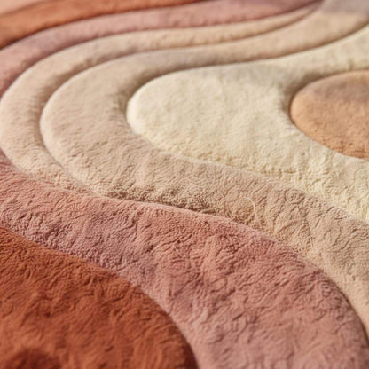 Boho area rug with modern abstract wave design in earth tones and plush texture