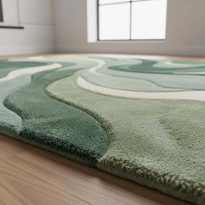 Abstract green area rug with modern sculpted wave pattern and plush tufted texture