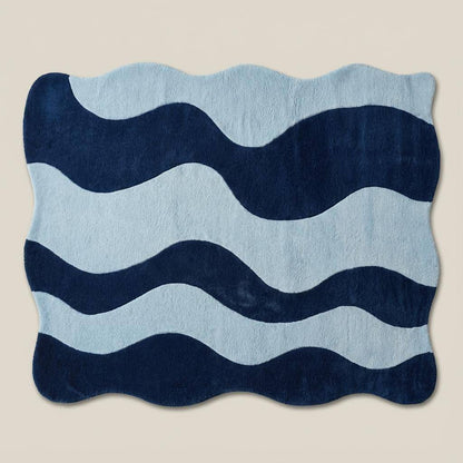 Soft plush wavy rug in two-tone blue color palette featured on herringbone wood flooring for modern home decor.