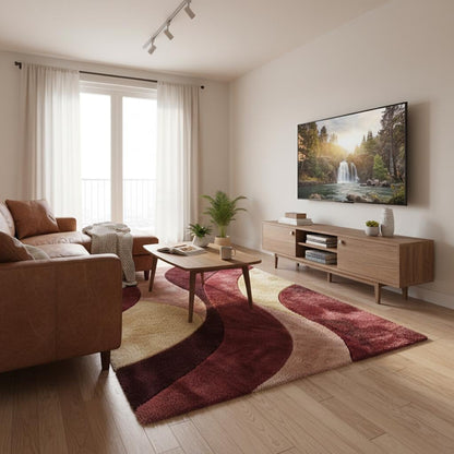 Soft retro modern accent rug featuring curved wave pattern in burgundy, cream, and blush hues.