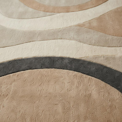Hand tufted wool rug with organic shape and neutral tones for modern home decor