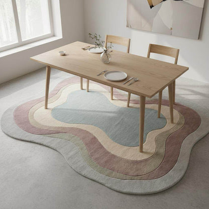 Cozy modern decor scene featuring a handcrafted wool rug with soothing color gradients and curved, organic edges.