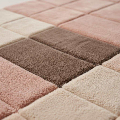 Modern geometric rug with plush pink neutral textured grid pattern for living room and bedroom