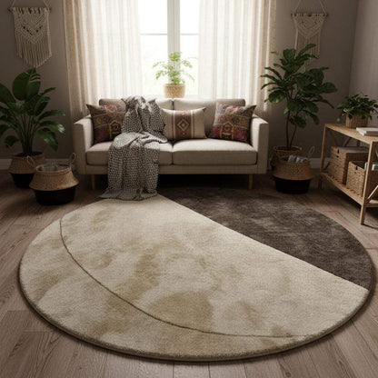 Contemporary circular rug with minimalist geometric design in warm taupe and ivory tones, shown in a modern interior setting.