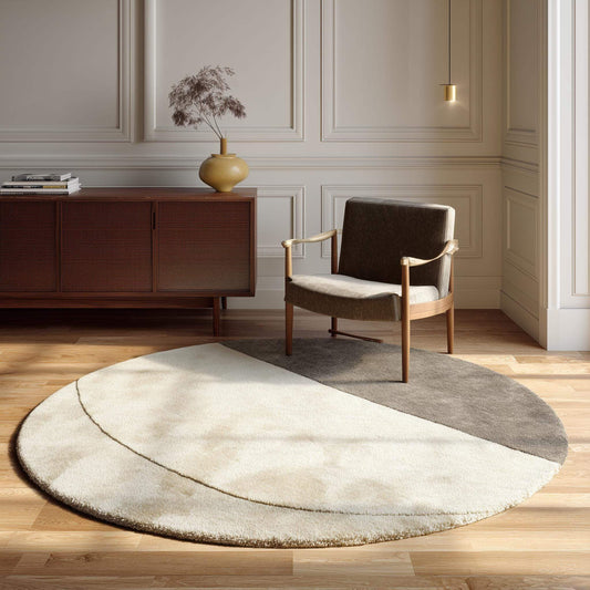 Modern round area rug with two tone cream and taupe plush tufted texture and geometric pattern