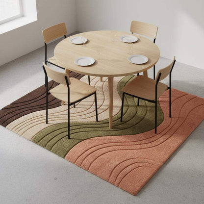 Textured contemporary rug with curved layered waves in peach, green, cream, and cocoa tones placed on a neutral floor.