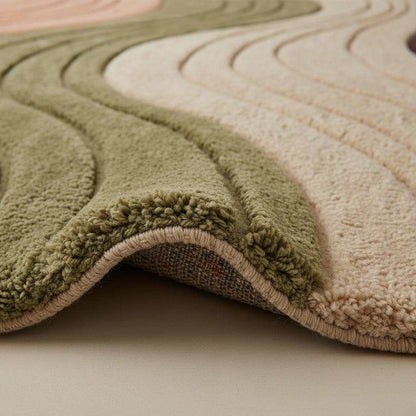 Beige modern wavy area rug with textured hand-tufted waves and plush high pile carpet
