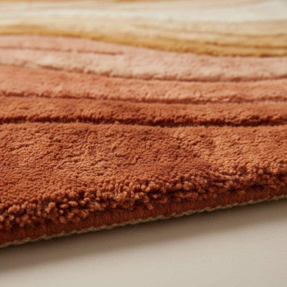 Mid century modern rug with sculpted wave design in warm earth tones for retro boho decor