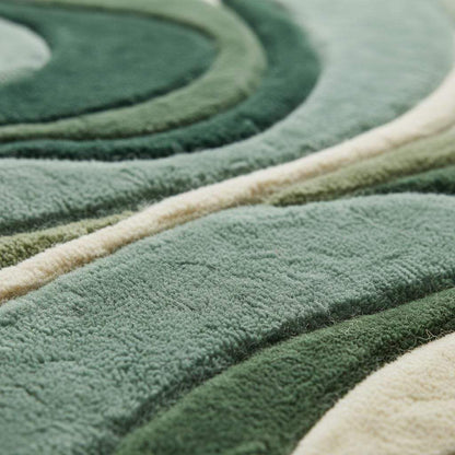Abstract green area rug with sculpted organic wave pattern and plush texture