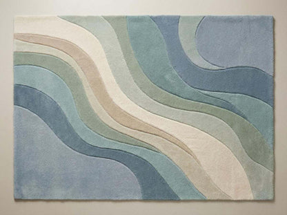 Top-down view of modern abstract wave pattern rug displaying full design, flowing curves, and blended pastel blue and green color palette