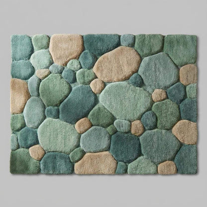 Top-down view of pebble pattern area rug displaying full organic stone design, rounded shapes, color variation, and sculpted texture across the entire rug surface.