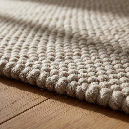 Chunky wool rug with thick loop weave in neutral beige for cozy minimalist Scandinavian decor
