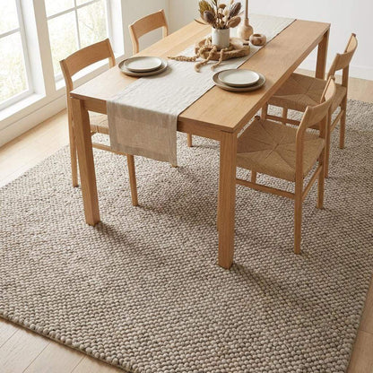 Chunky wool rug with thick beige loops in minimalist Scandinavian living room